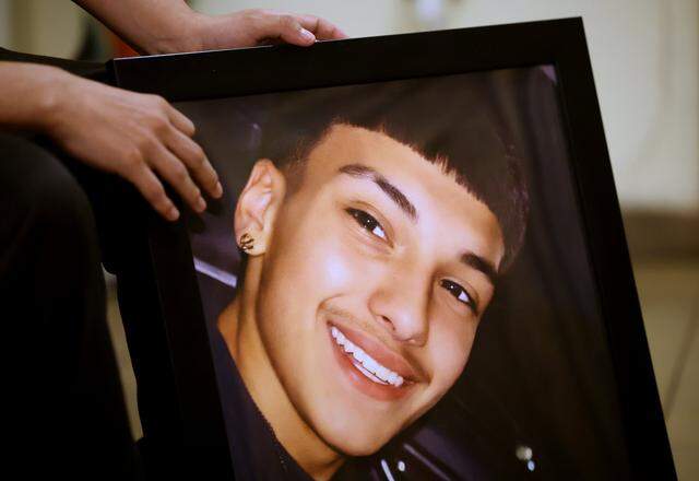 Arian Gonzalez holds a photograph of his brother, Jesus. Jesus Gonzalez was killed in a suspected drunk-driving crash in January. He was a passenger in a car driven by his friend, Israel Suastegui.